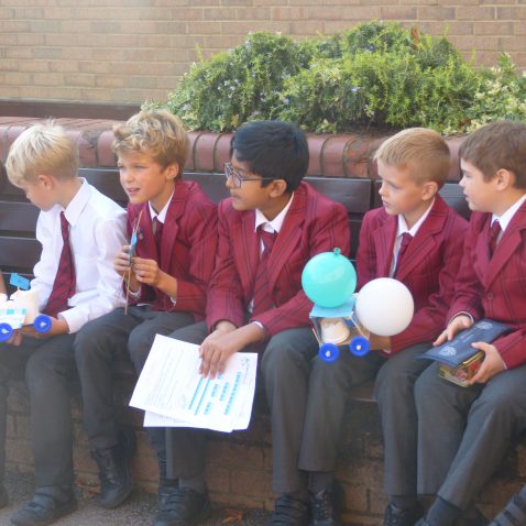 students sat in a row on a bench