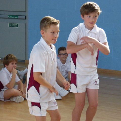 group of school boys in PE kit in school sports hall