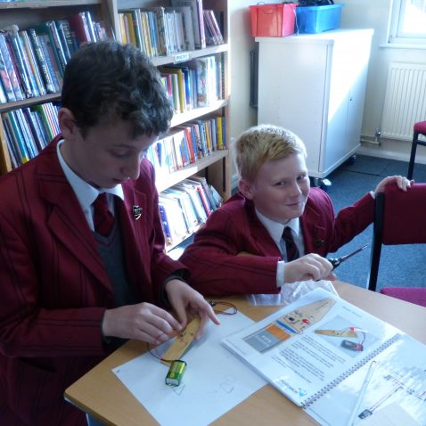 two school boys doing a science experiment