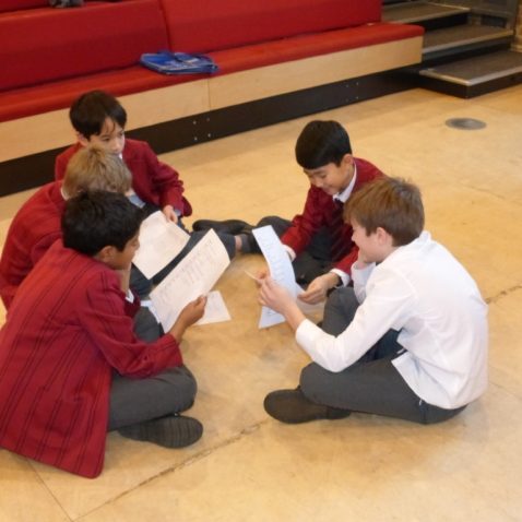 boys reading through scripts