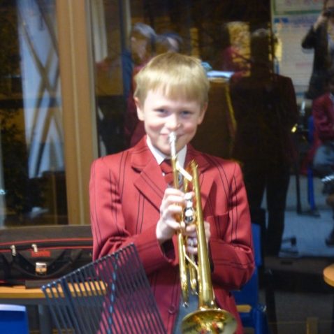 boy playing the French horn