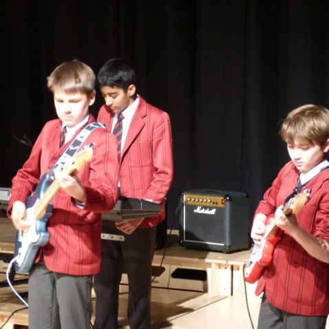 boys playing electric guitar and keyboard