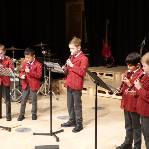 Children using recorders to play music