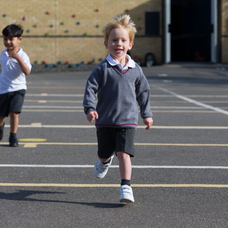 child running across the playground