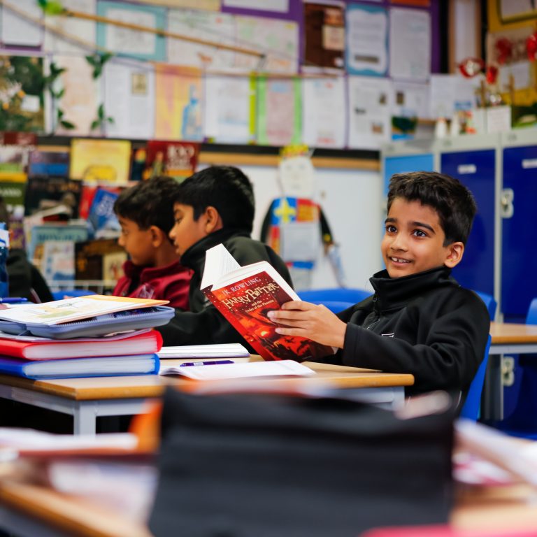 Child reading a Harry Potter book