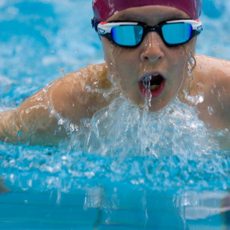 child performing a breast stroke