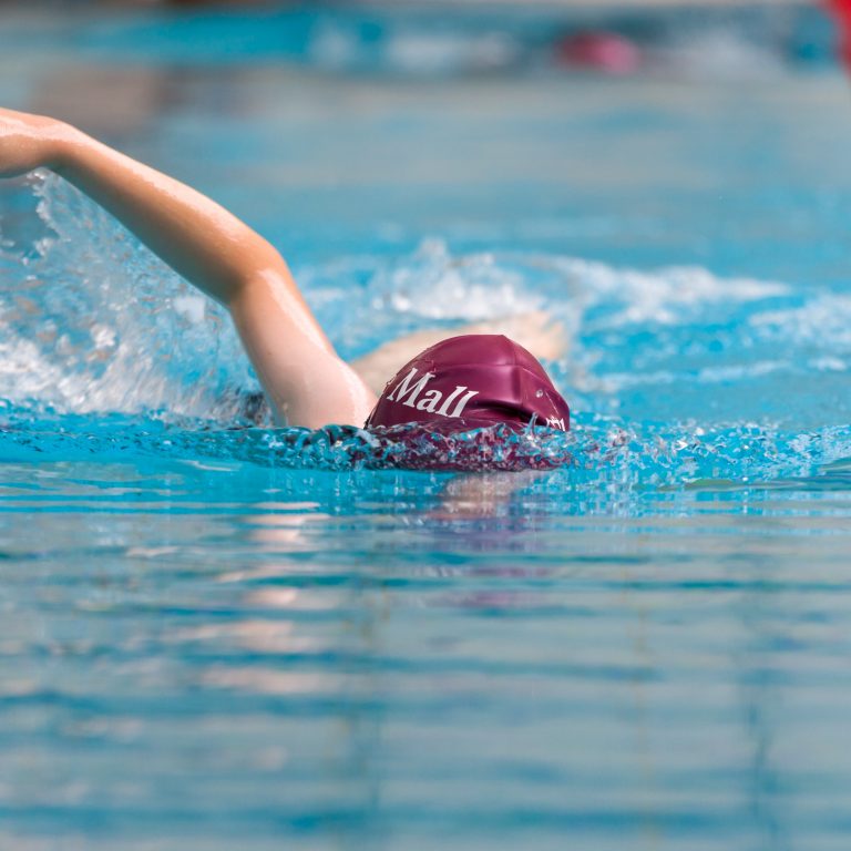 child in the swimming pool doing front crawl