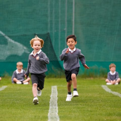 children racing on outdoor track