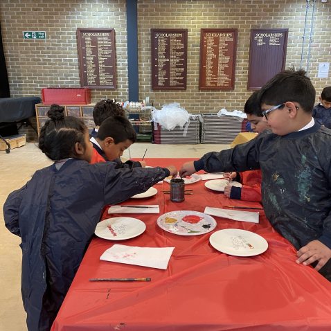 children painting with aprons on