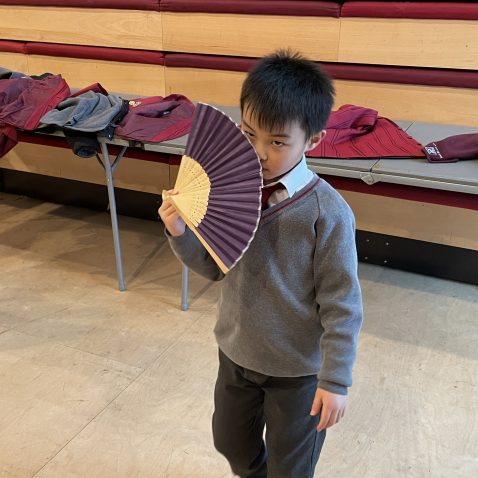 student with a hand fan