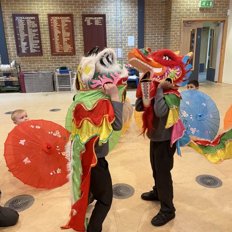 students wearing dragon costume
