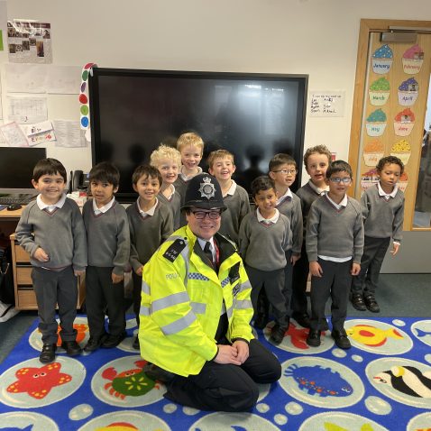 children standing next to a police officer