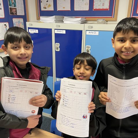 children holding up their work