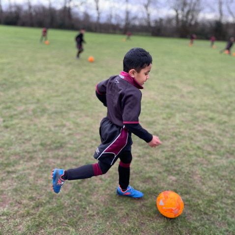student playing football