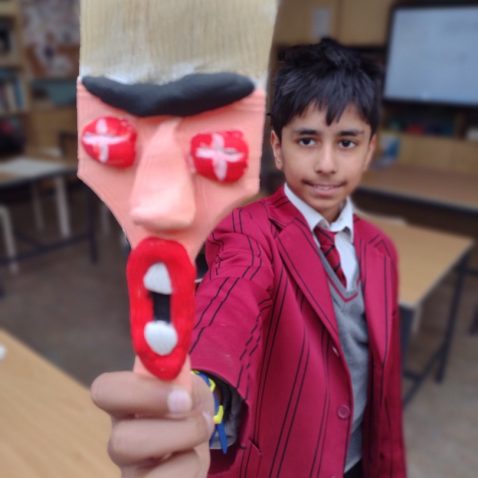 student holding a paintbrush