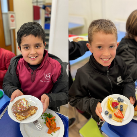 students holding pancakes