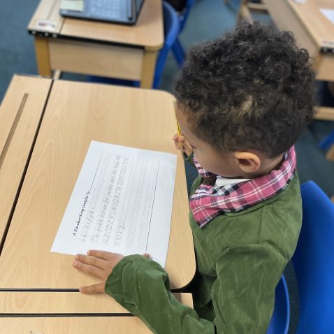 student writing out onto a piece of paper