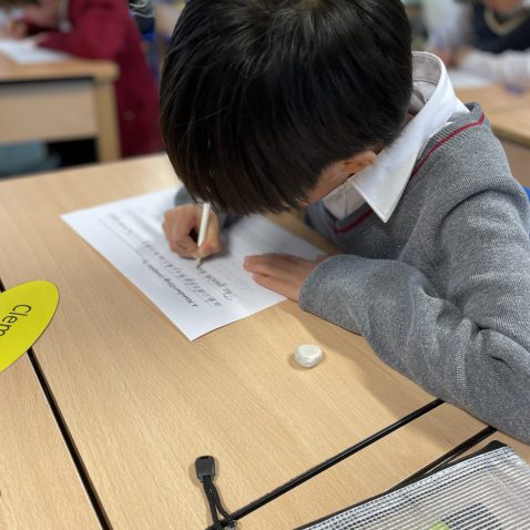 boy writing onto paper