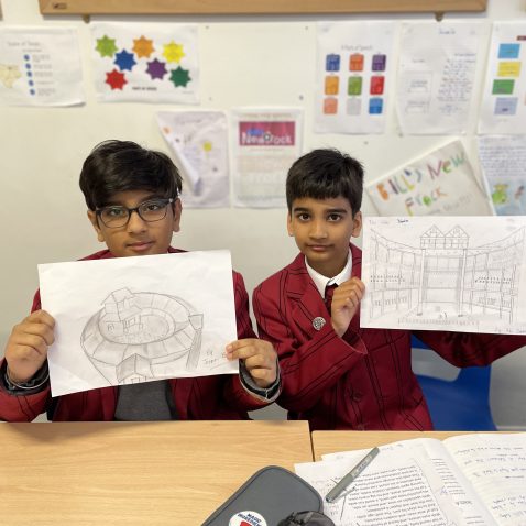 students showing off their drawings