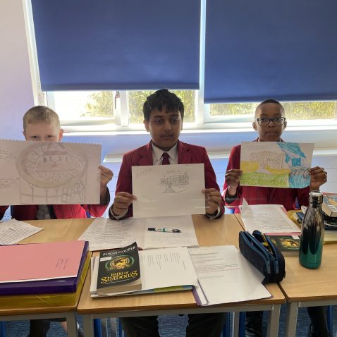 students showing off their drawings
