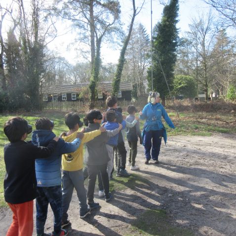 students with arms around their shoulders