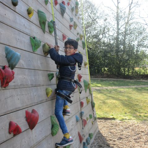 student using a large climbing frame