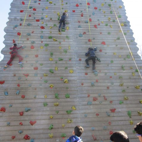 students using a large climbing frame