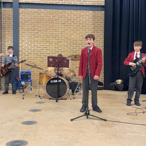 children playing guitars and boy singing