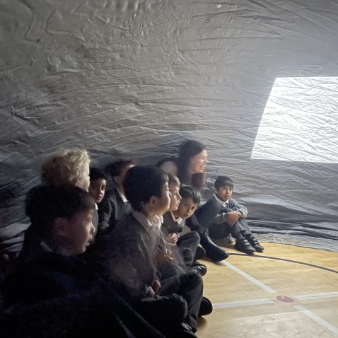 children sat in a silver dome