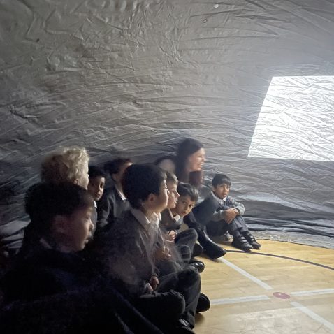 children sat in a silver dome
