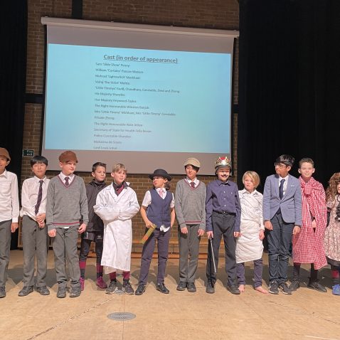 children stood in a line wearing costumes