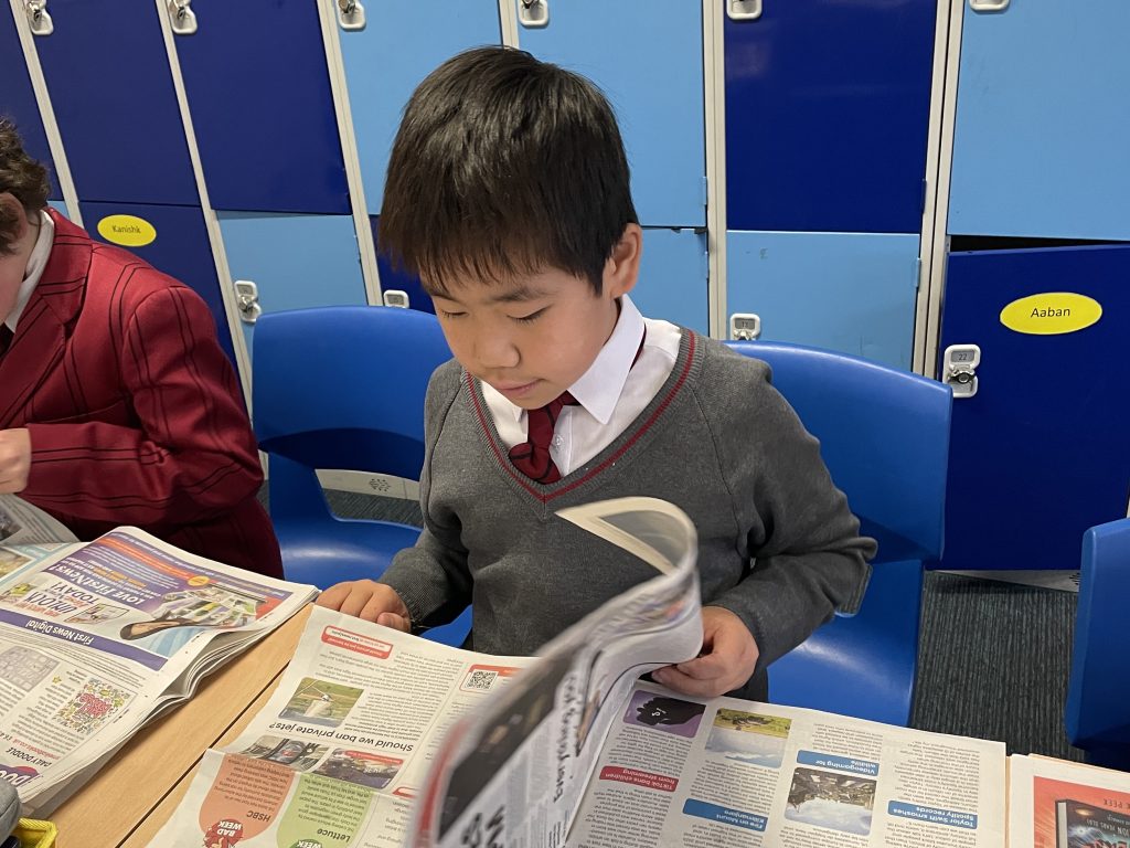 student flicking through a newspaper