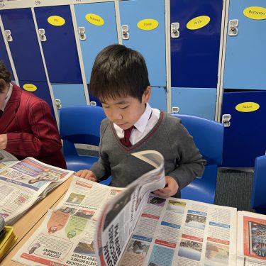student flicking through a newspaper
