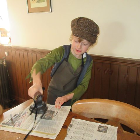 student holding an old cast iron