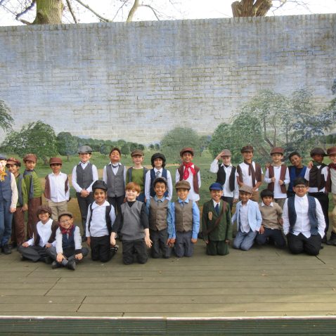group of boys all wearing clothes from the 1900s