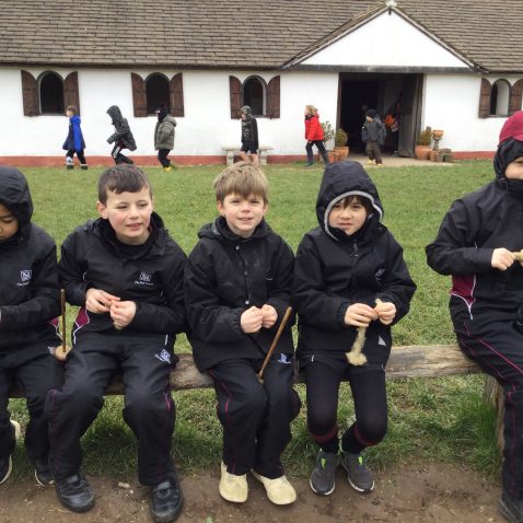 students sat on a wooden plank