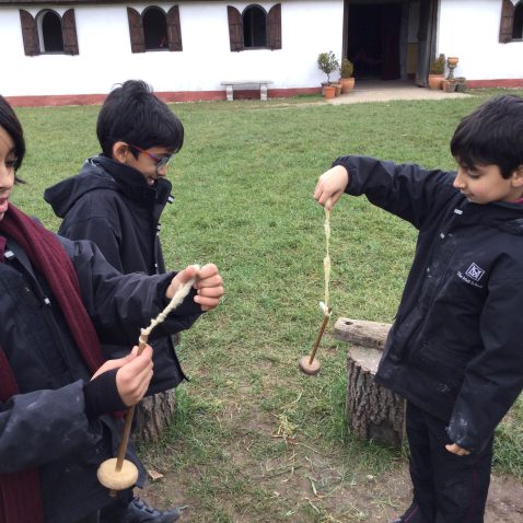 students looking at wooden tools