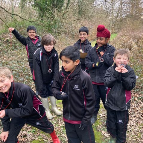 students with their compasses and magnifying glasses