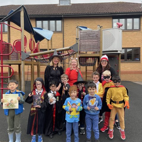 students outside in the playground in their outfits for world book day
