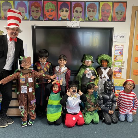 students and a teacher in fancy dress costumes