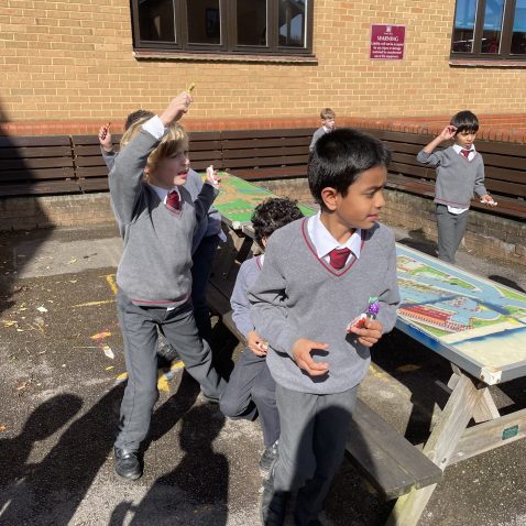students playing as they hold sweets in their hands