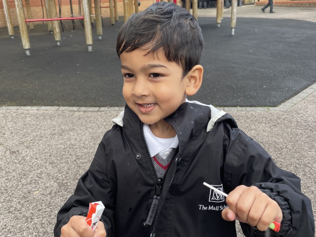 student holding 2 lollipops in his hands