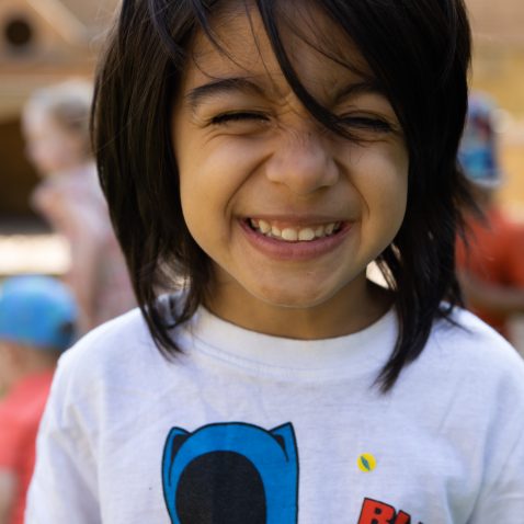 smiling child with a Black Panther t-shirt on