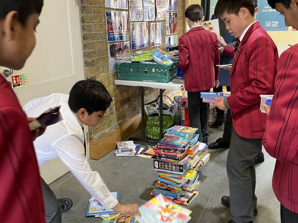 students piling books on the floor