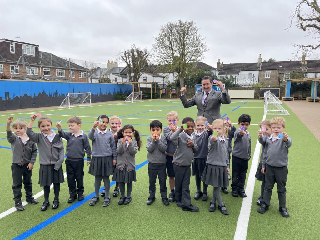 students holding little easter eggs