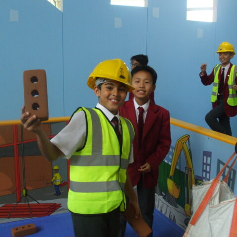 students pretending to be construction workers