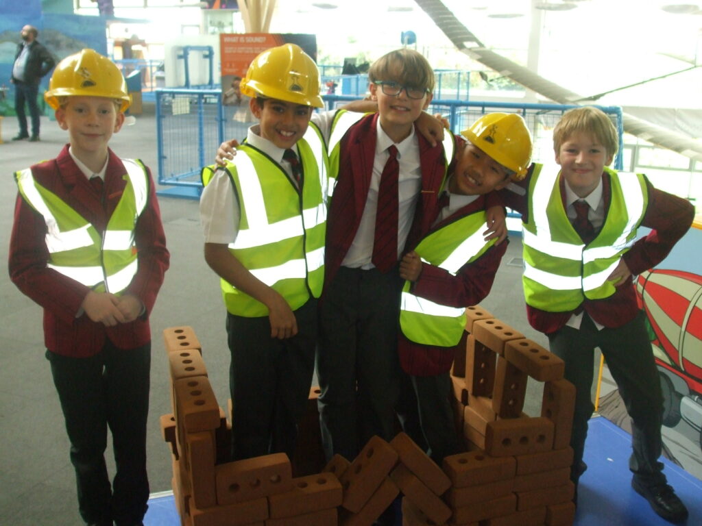 students pretending to be construction workers