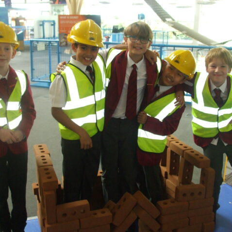 students pretending to be construction workers