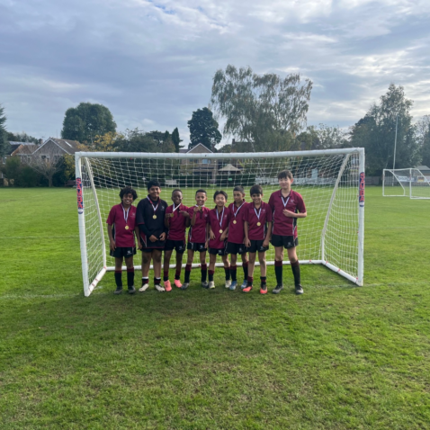 students in a football goal post