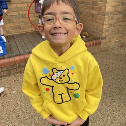 boy in a children in need top